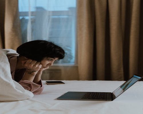 Person looking away from their laptop screen, resting their eyes